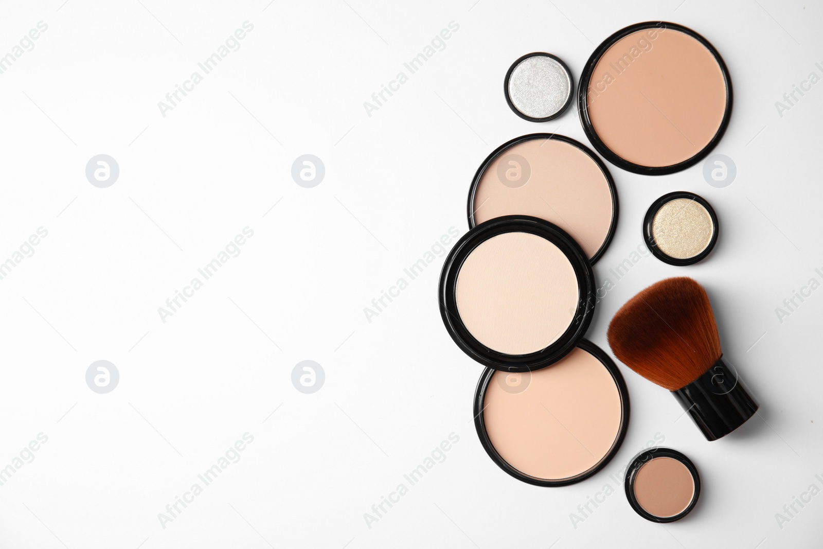 Photo of Flat lay composition with different makeup face powders on white background. Space for text