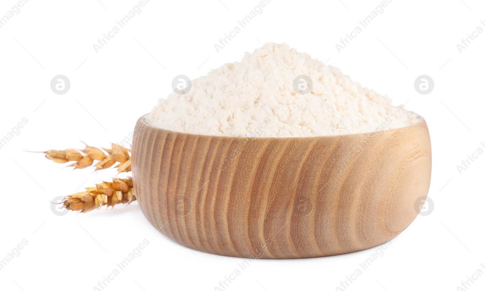 Photo of Wooden bowl with wheat flour on white background