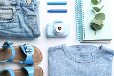 Flat lay composition with little photographer's toy camera on white background