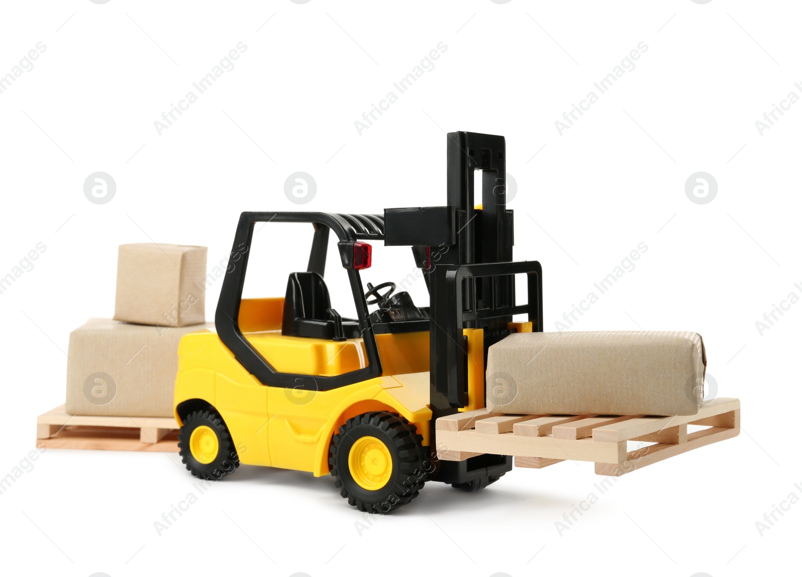 Photo of Toy forklift, wooden pallets and boxes on white background