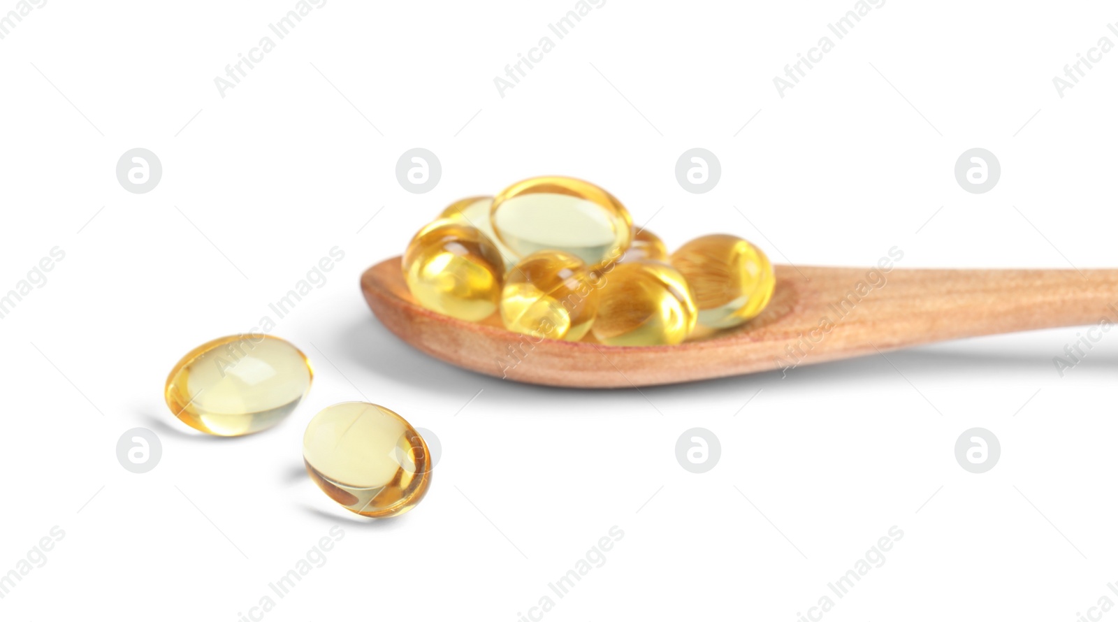 Photo of Spoon with cod liver oil pills on white background