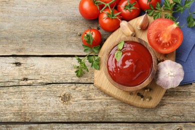 Photo of Tasty ketchup, fresh tomatoes, parsley and spices on wooden table, flat lay. Space for text