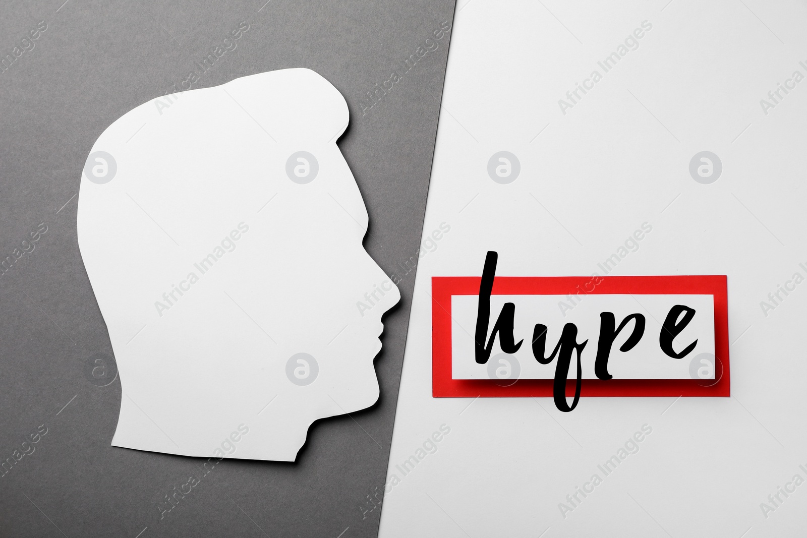 Image of Card with word Hype and head paper cutout on color background, flat lay