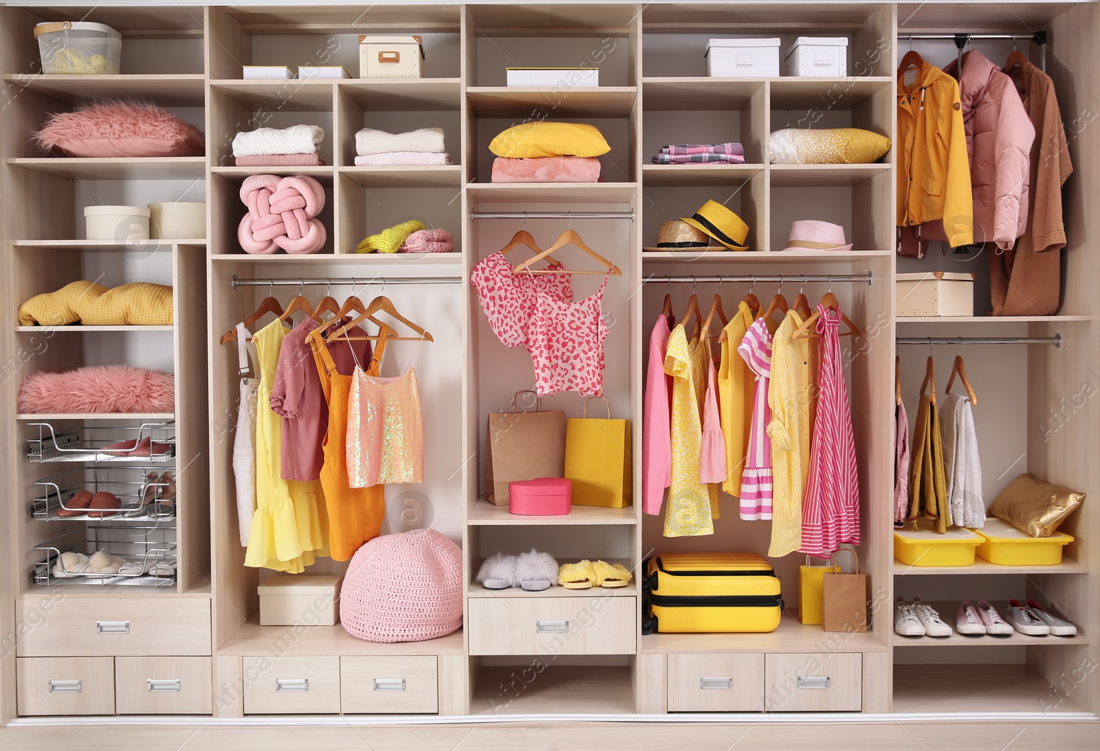 Photo of Stylish clothes, shoes and accessories in large wardrobe closet