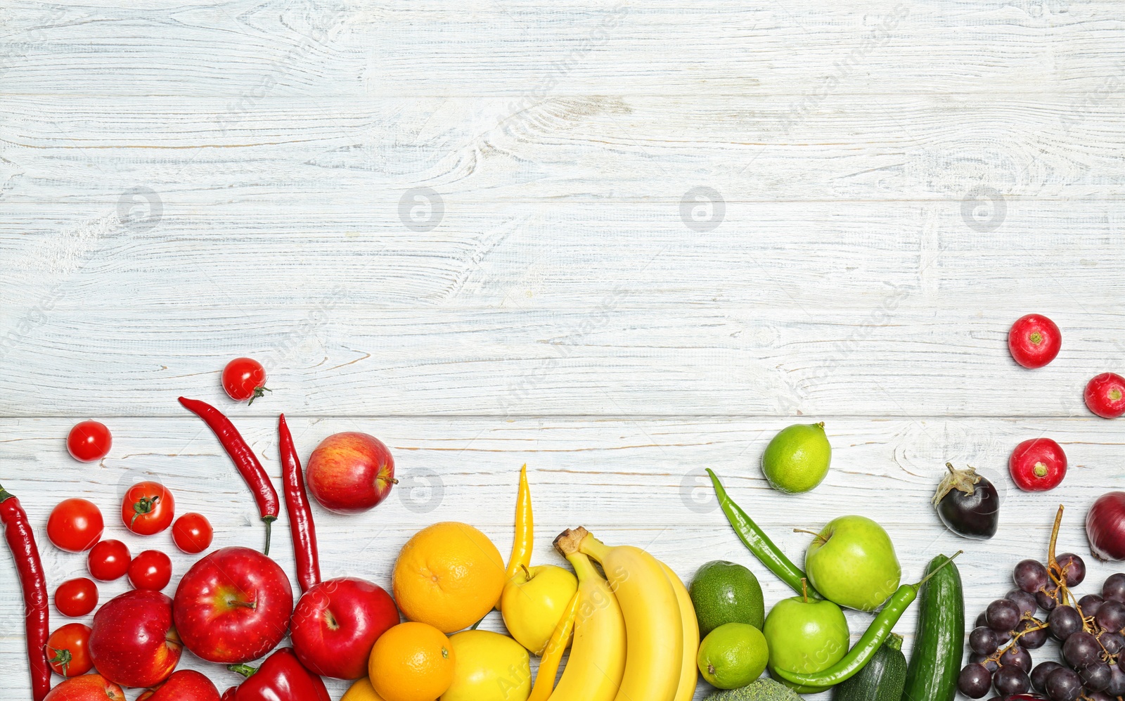 Photo of Rainbow composition with fresh vegetables and fruits on wooden background, flat lay