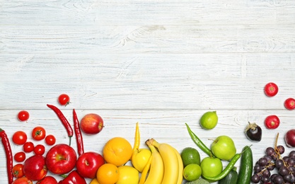 Photo of Rainbow composition with fresh vegetables and fruits on wooden background, flat lay