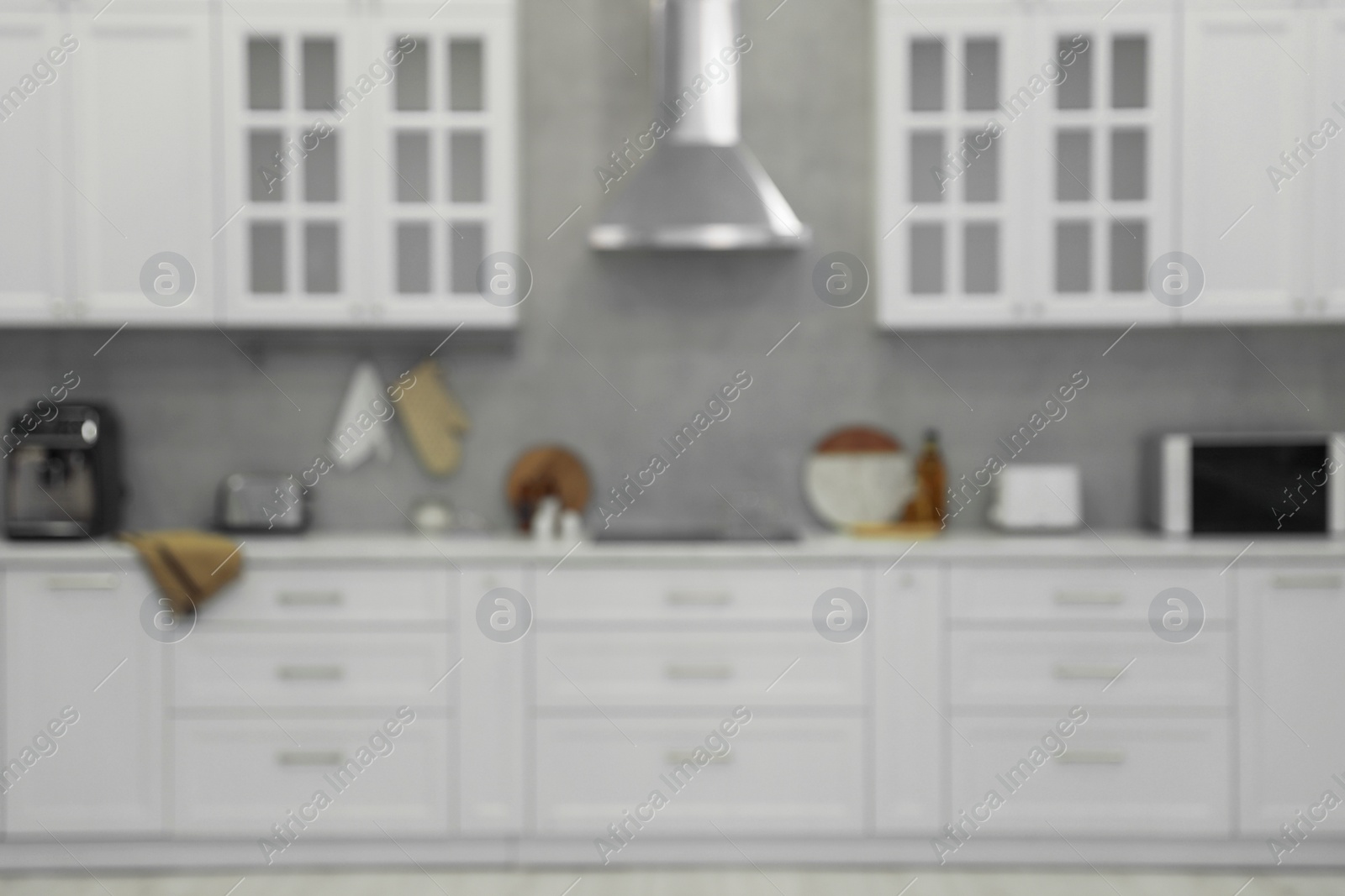 Photo of Stylish spacious kitchen with furniture, blurred view. Interior design