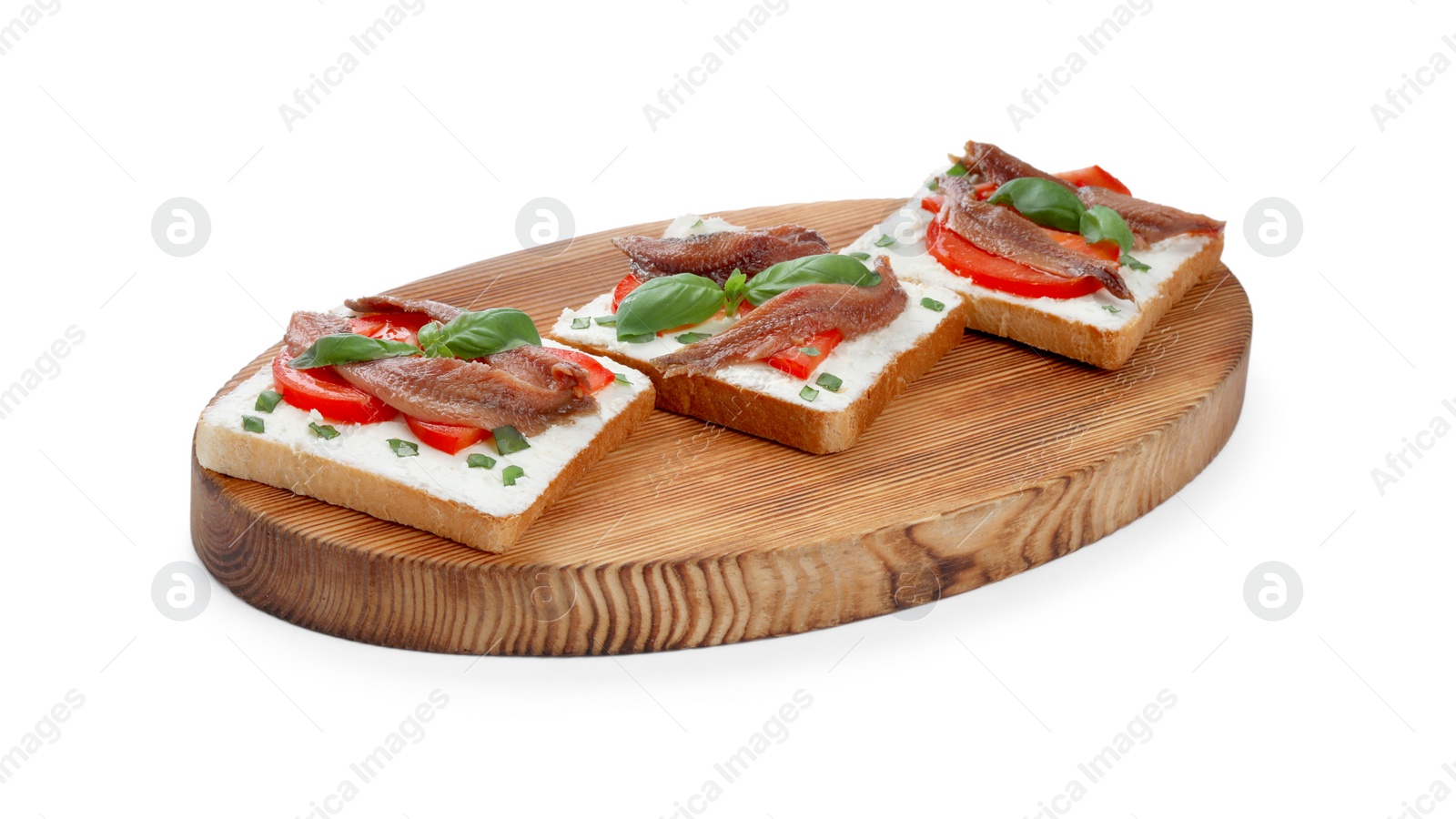 Photo of Delicious sandwiches with cream cheese, anchovies, tomatoes and basil on white background