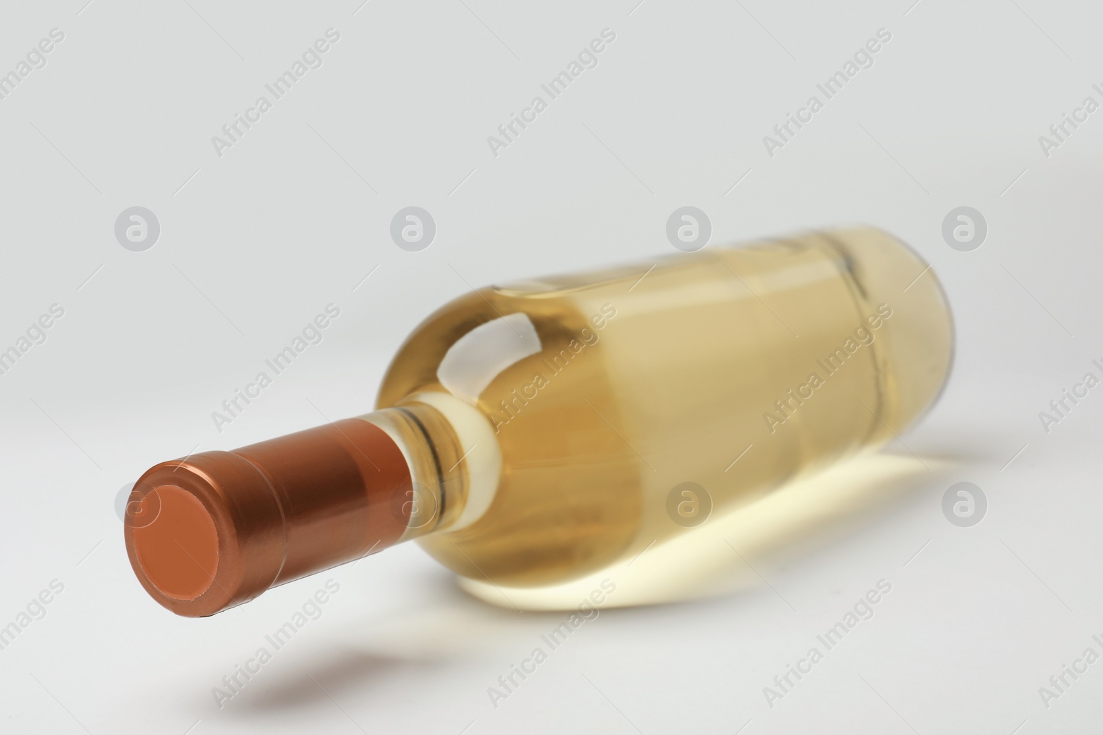 Photo of Bottle of expensive white wine on light background