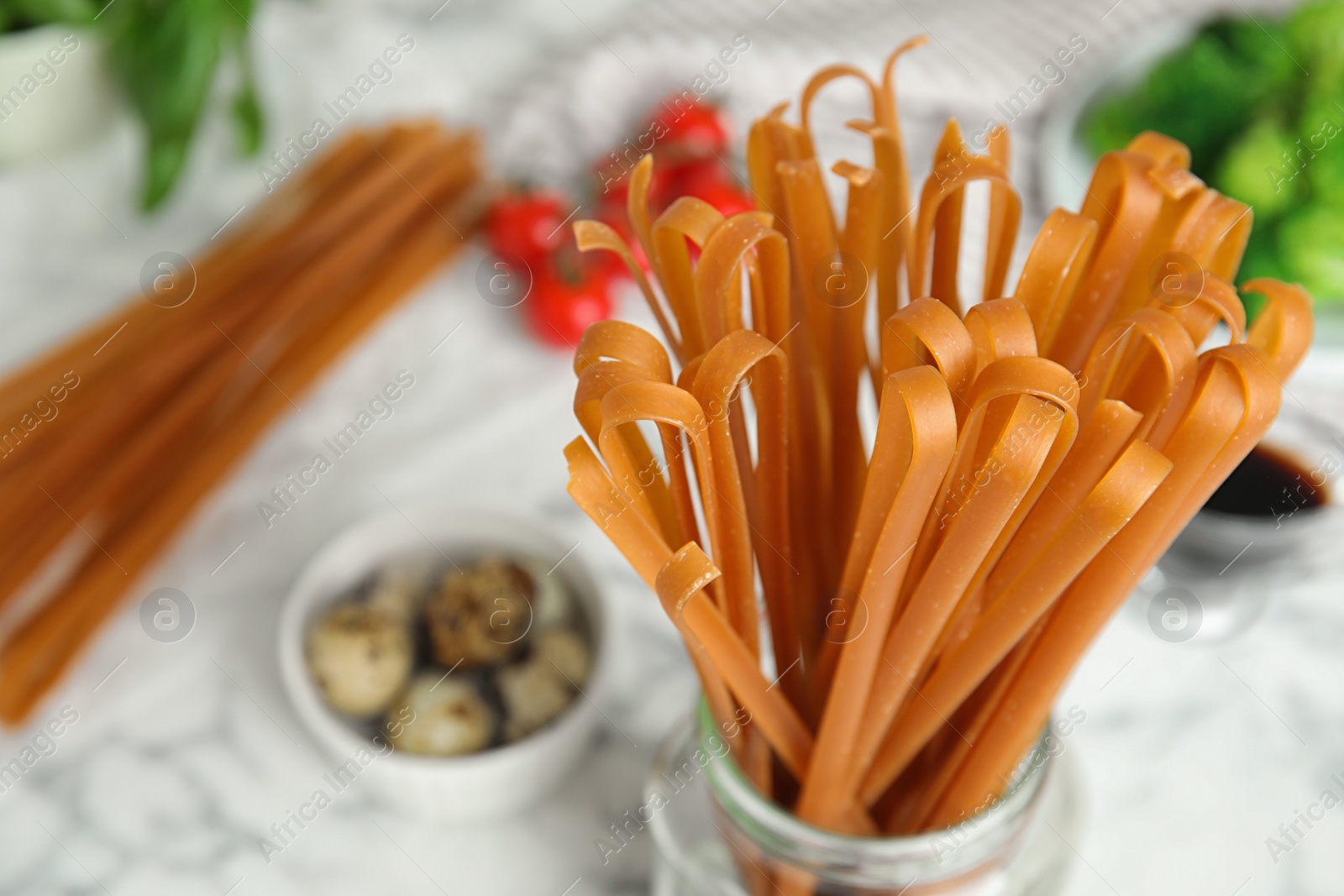 Photo of Uncooked buckwheat noodles on table, closeup. Space for text