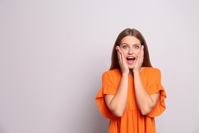 Photo of Portrait of surprised young woman on white background
