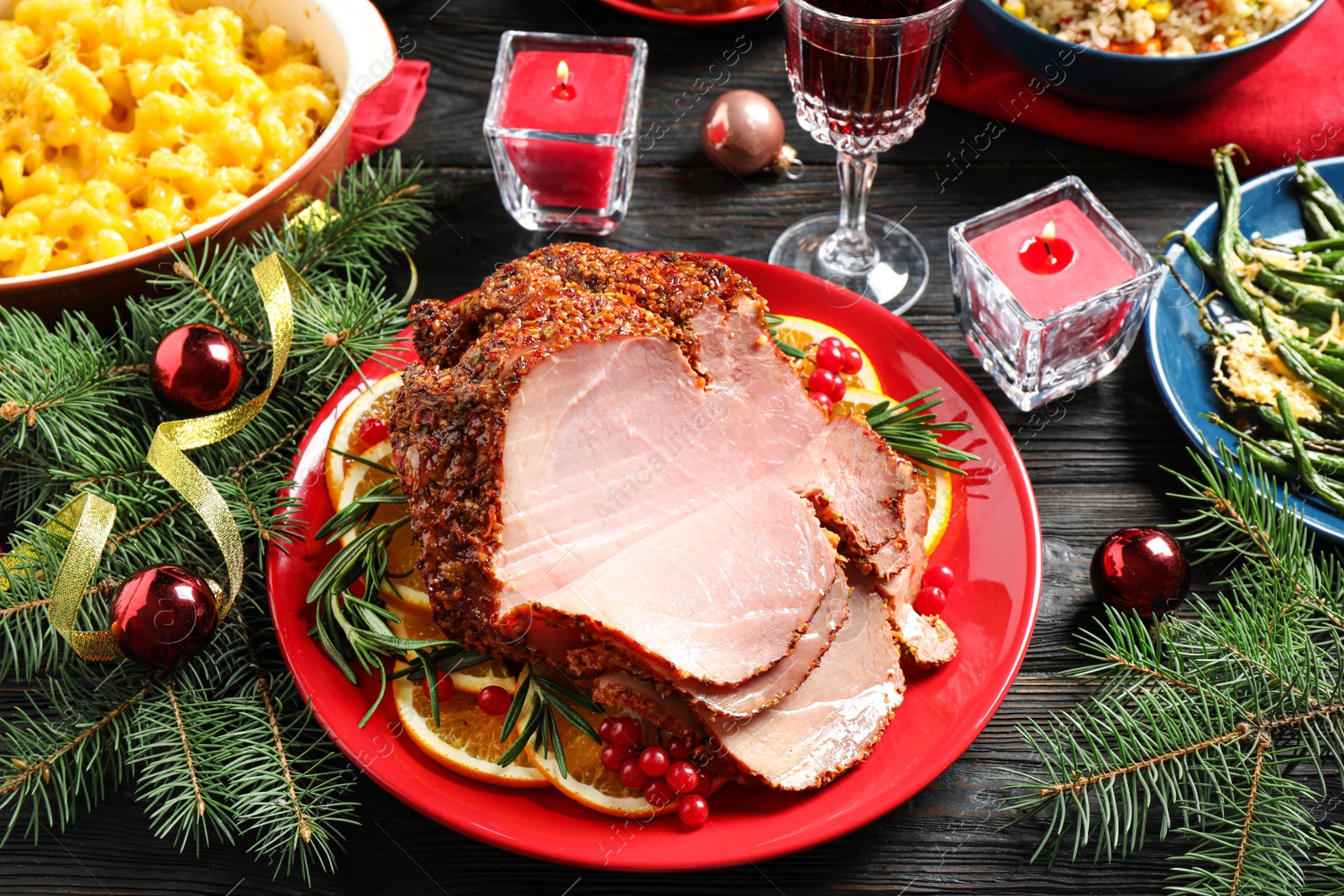 Photo of Plate with delicious ham served on dark wooden table. Christmas dinner