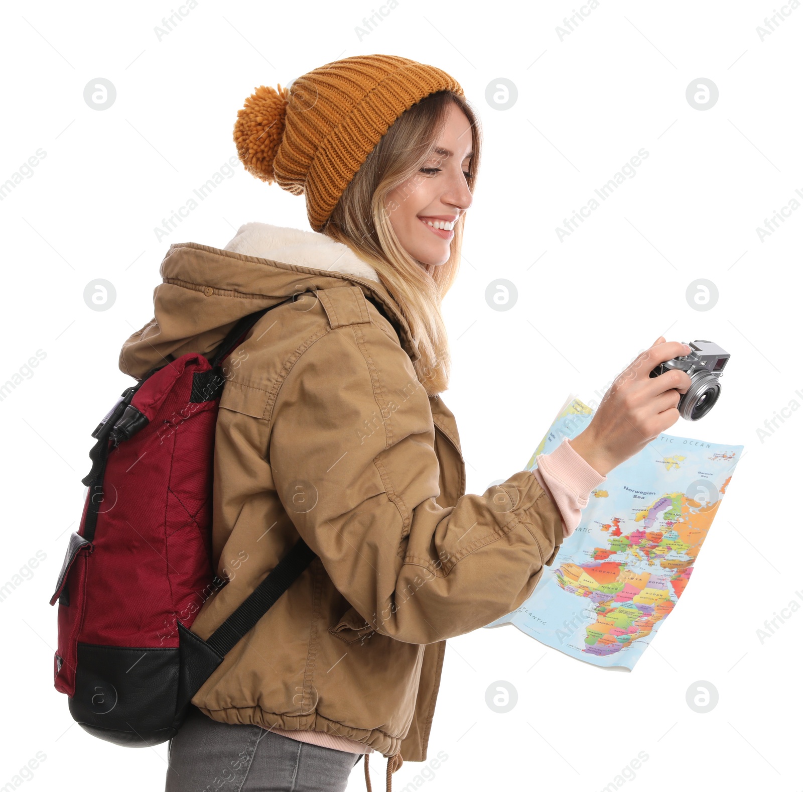 Photo of Woman with map and backpack taking picture on white background. Winter travel