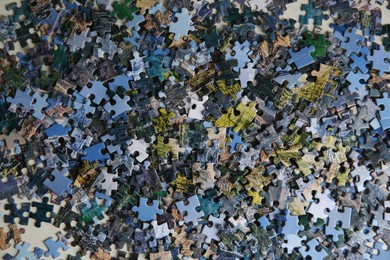 Jigsaw puzzle pieces on table, flat lay