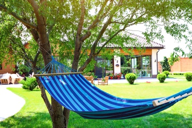Comfortable blue hammock outdoors on sunny day