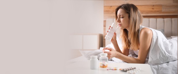 Image of Woman taking medicine for hangover at home, space for text. Banner design