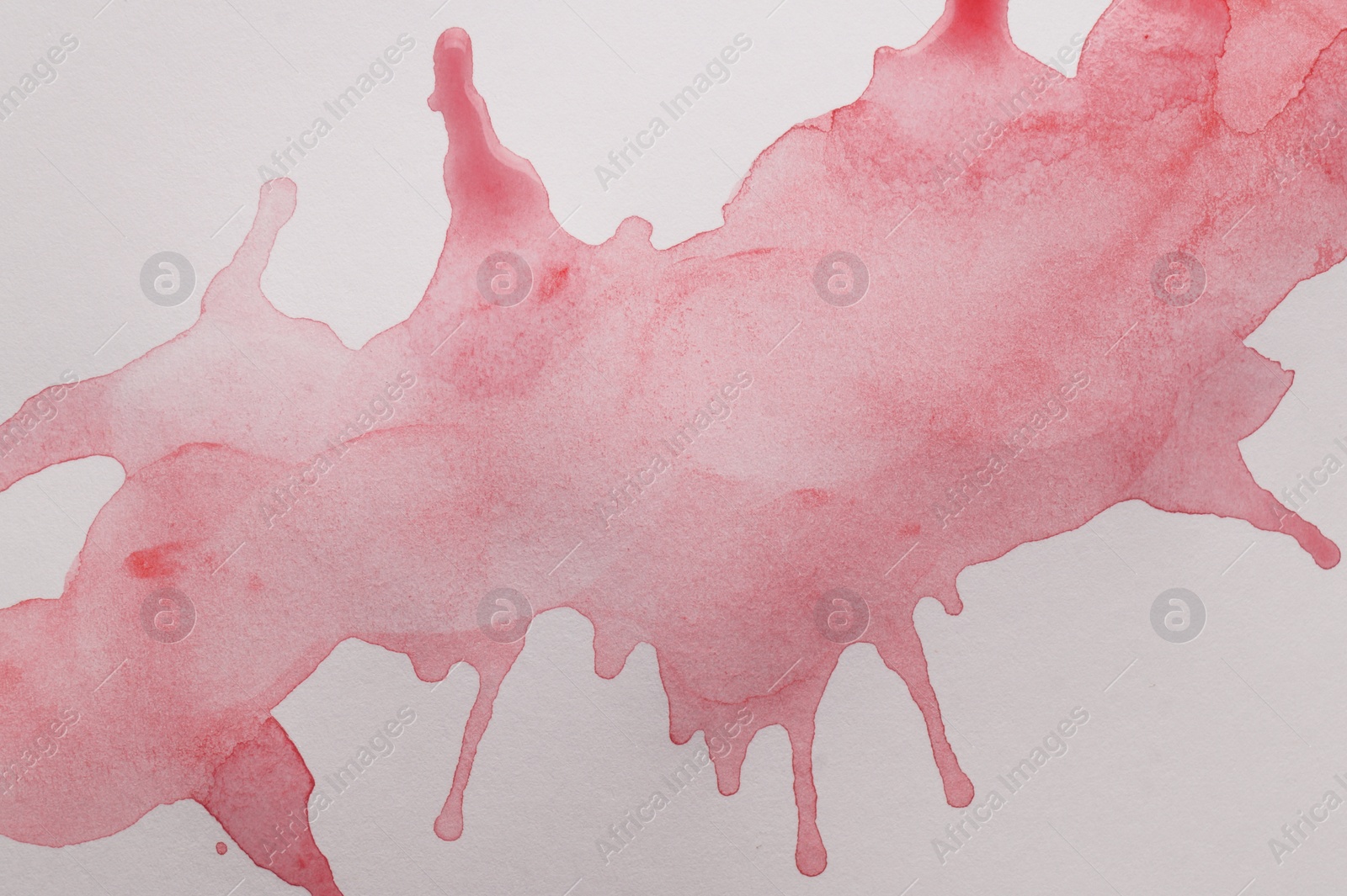 Photo of Pink watercolor blots on white canvas, top view