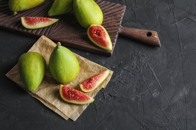 Photo of Fresh ripe figs on dark background. Tropical fruit