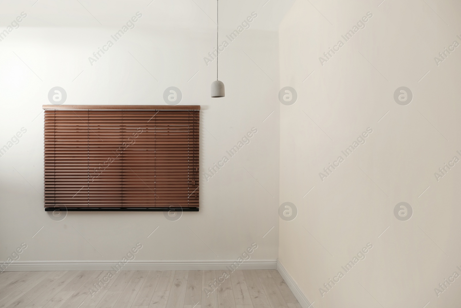 Photo of Modern window with closed stylish wooden blinds indoors. Space for text