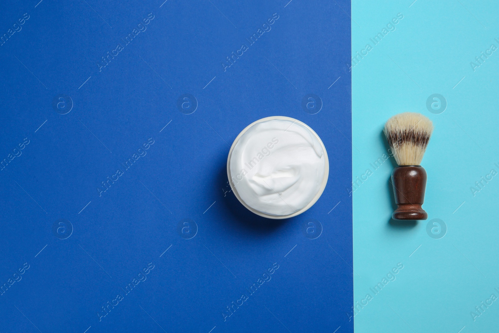 Photo of Flat lay composition with shaving brush and cream on color background. Space for text