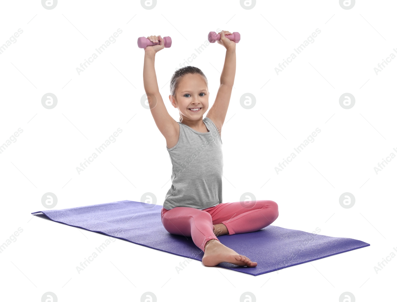 Photo of Cute little girl with dumbbells on white background