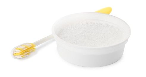 Photo of Bowl of tooth powder and brush on white background