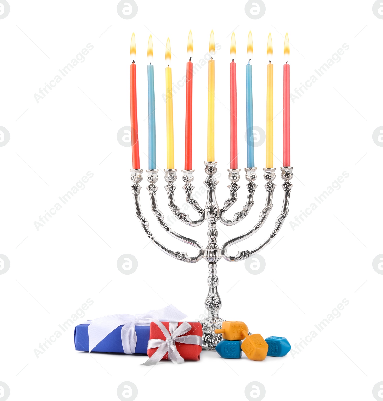 Photo of Hanukkah celebration. Menorah with candles, gift boxes and colorful dreidels isolated on white