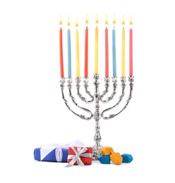 Photo of Hanukkah celebration. Menorah with candles, gift boxes and colorful dreidels isolated on white