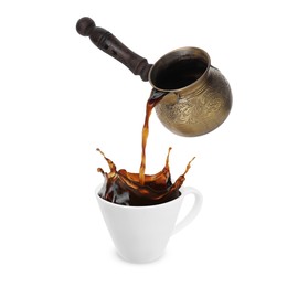 Pouring freshly brewed aromatic coffee from turkish pot into cup. Objects in air on white background