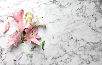 Photo of Flat lay composition with lily flowers on marble background