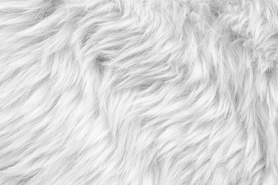 Texture of white faux fur as background, closeup
