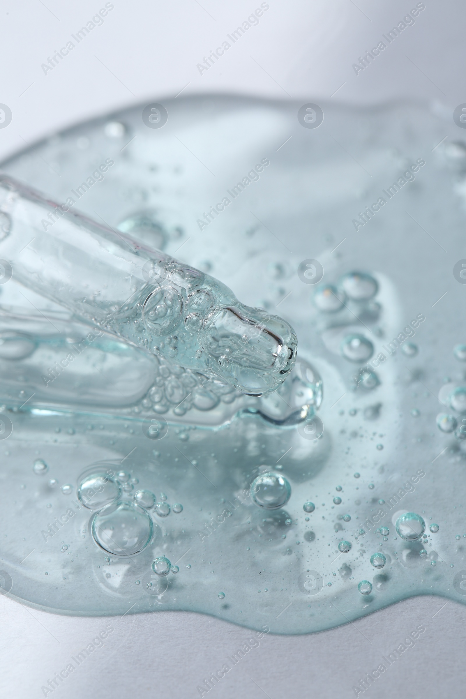 Photo of Pipettes with cosmetic serum on white background, closeup