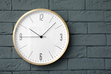 Modern clock on brick wall. Time concept