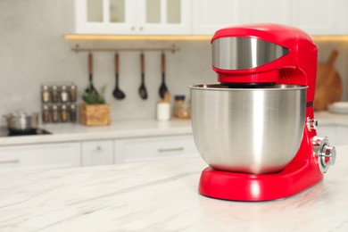 Photo of Modern red stand mixer on white marble table in kitchen, space for text