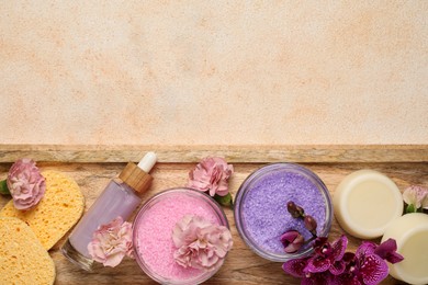 Aromatic sea salt and spa products on beige textured table, top view. Space for text