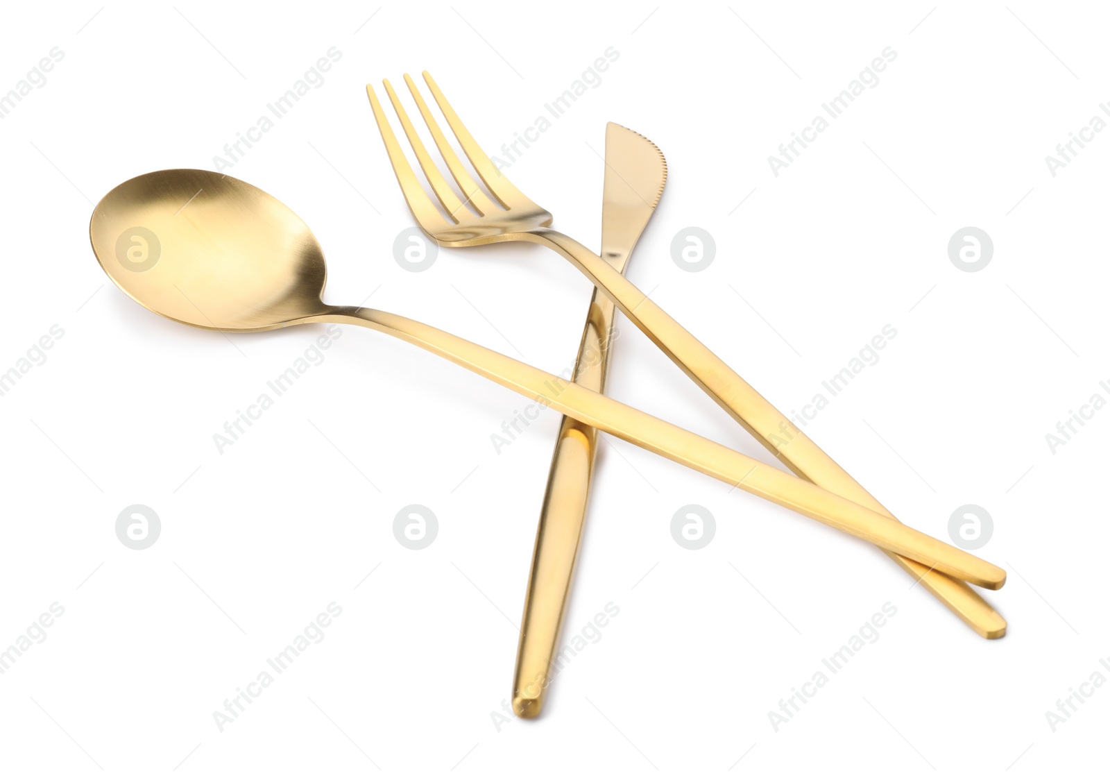 Photo of Shiny golden fork, knife and spoon isolated on white. Luxury cutlery set