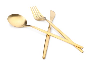 Photo of Shiny golden fork, knife and spoon isolated on white. Luxury cutlery set