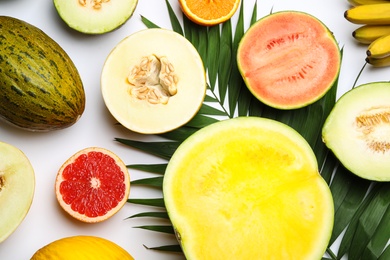 Composition with ripe tasty melons on white background, top view