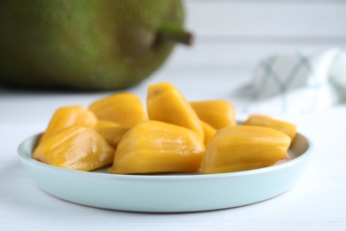 Delicious exotic jackfruit bulbs on white table, closeup