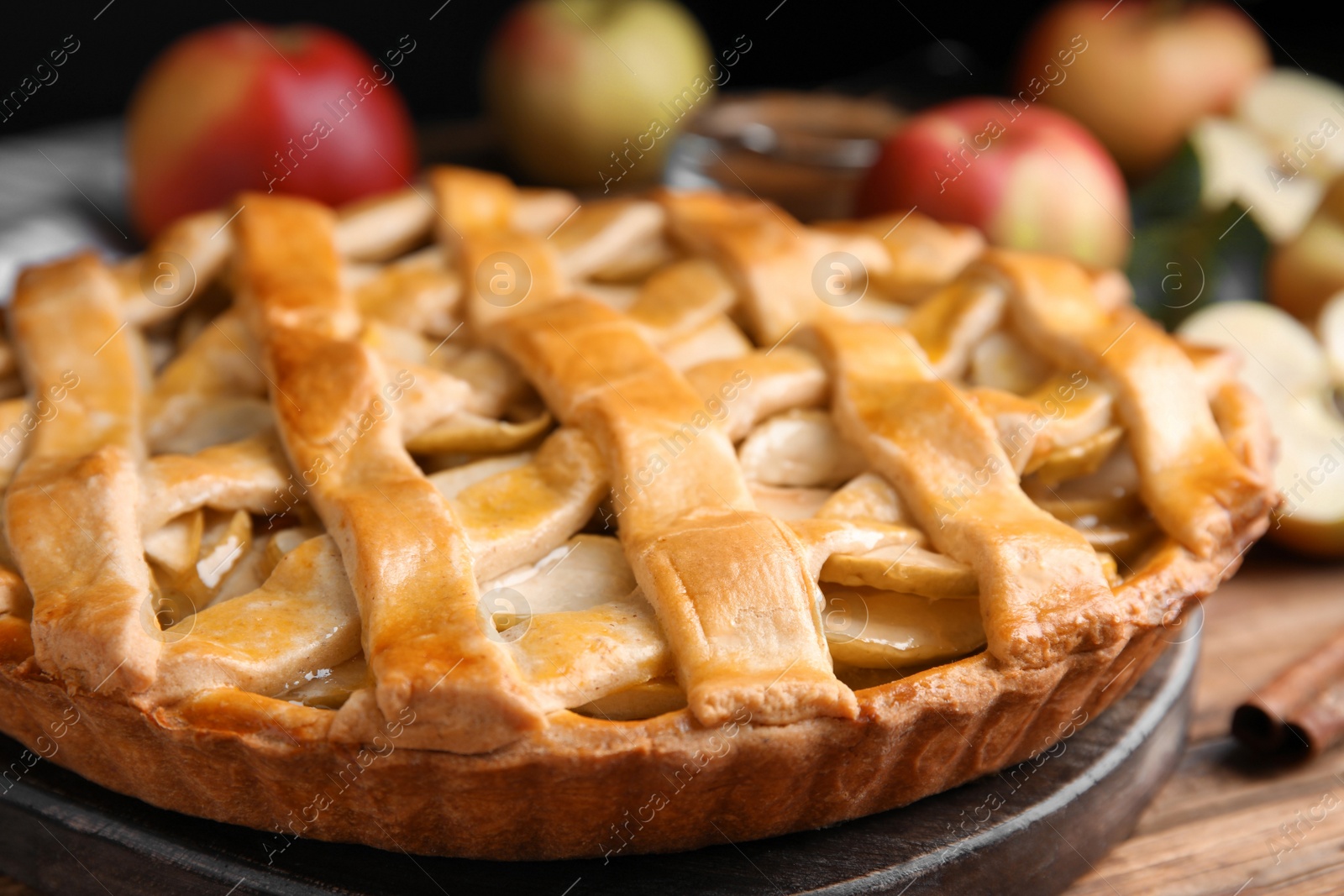 Photo of Delicious traditional apple pie on wooden table, closeup