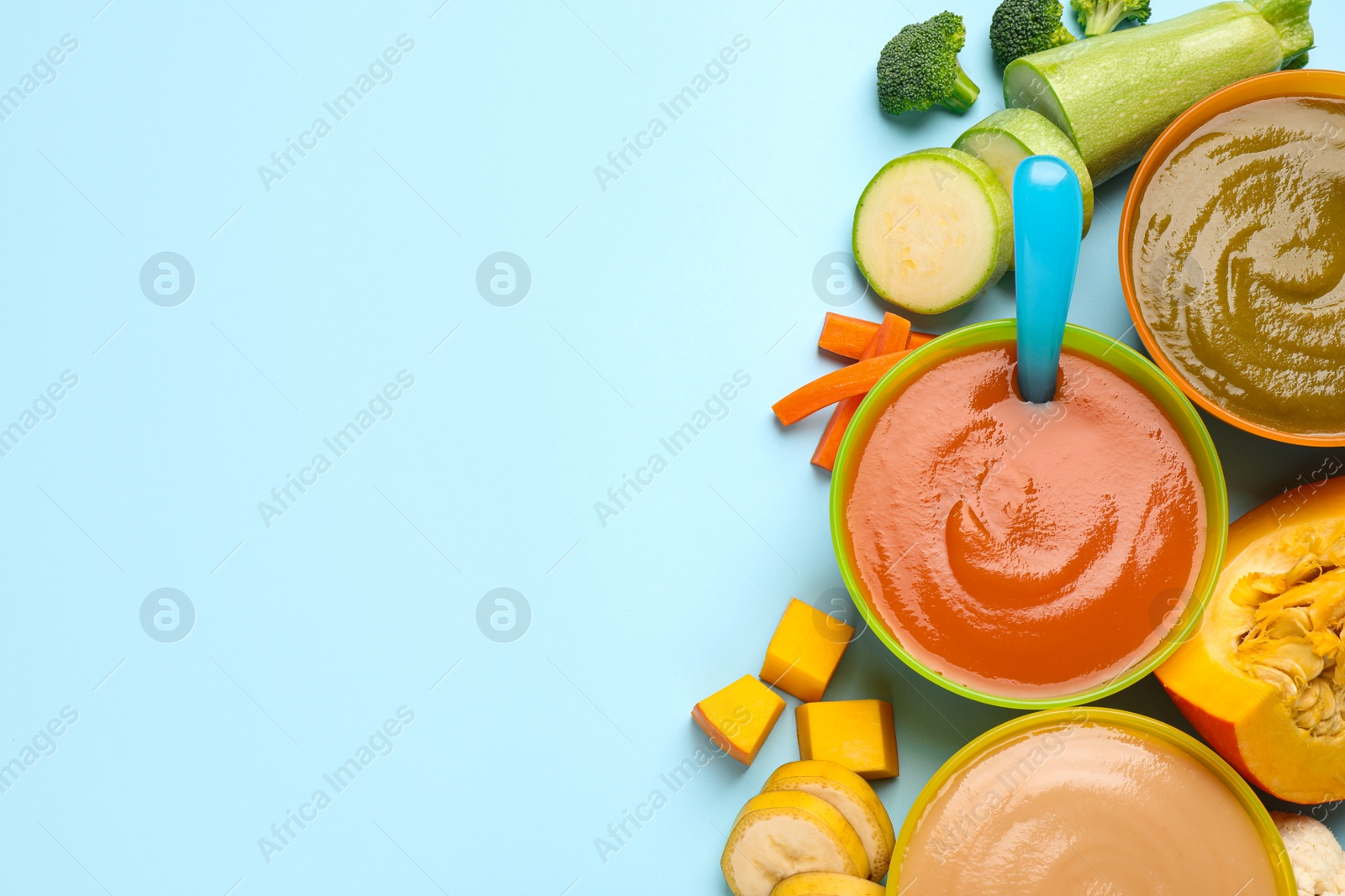 Photo of Healthy baby food and ingredients on light blue background, flat lay. Space for text