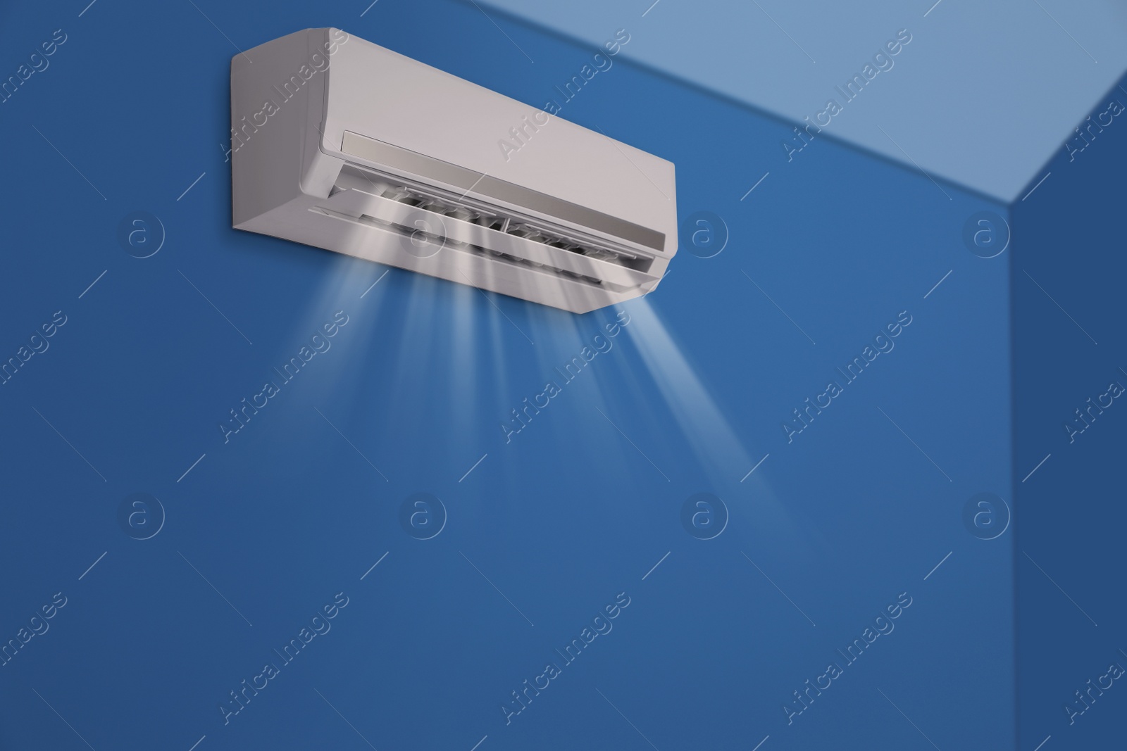 Image of Modern air conditioner on blue wall indoors