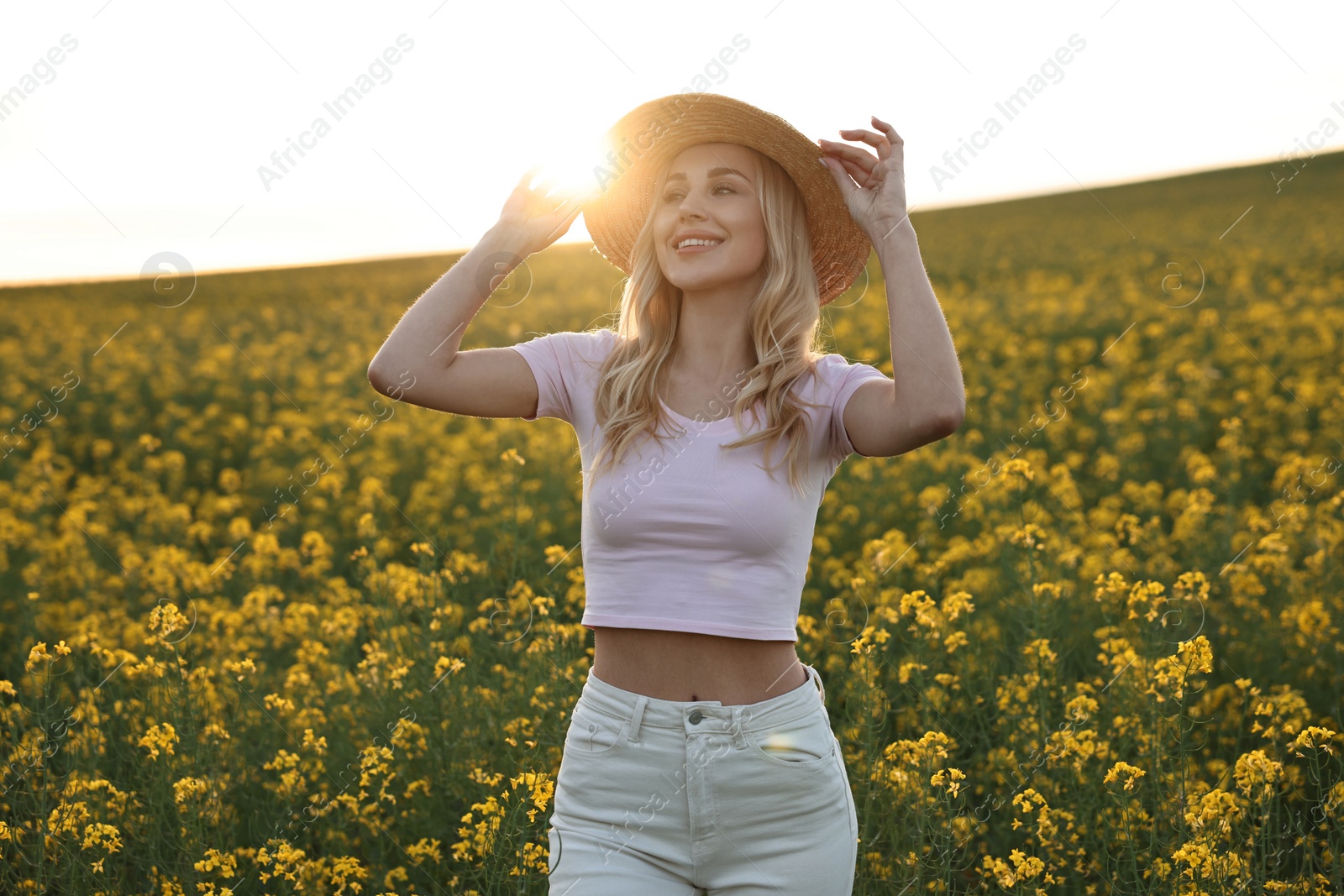 Photo of Portrait of happy young woman in field on spring day