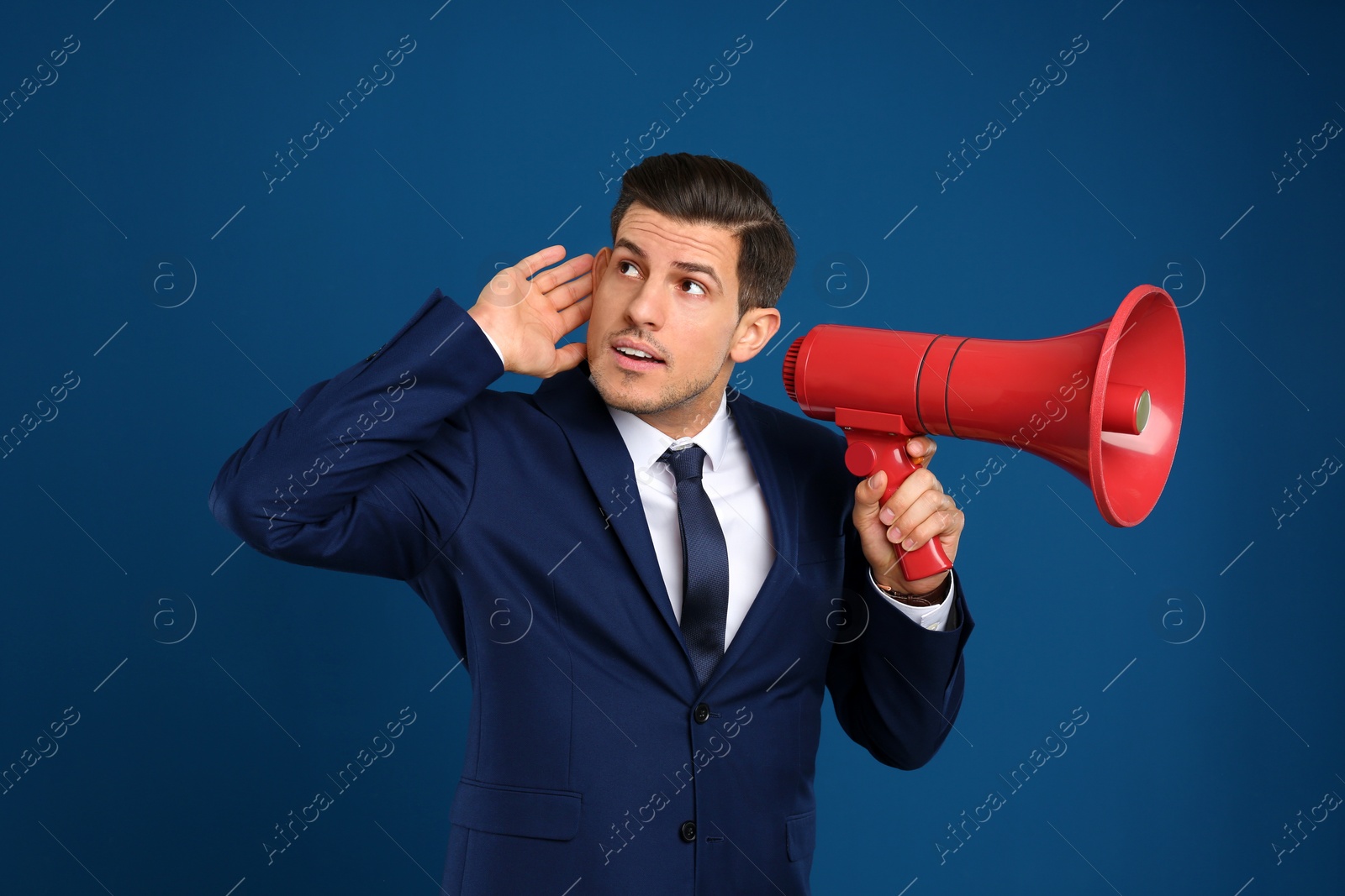 Photo of Handsome man with megaphone on blue background