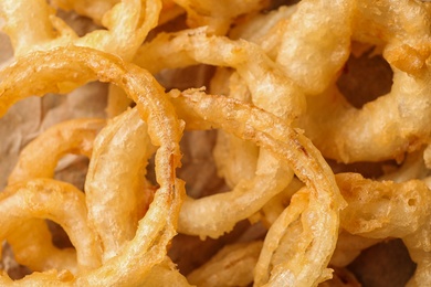 Homemade delicious golden breaded and deep fried crispy onion rings, closeup