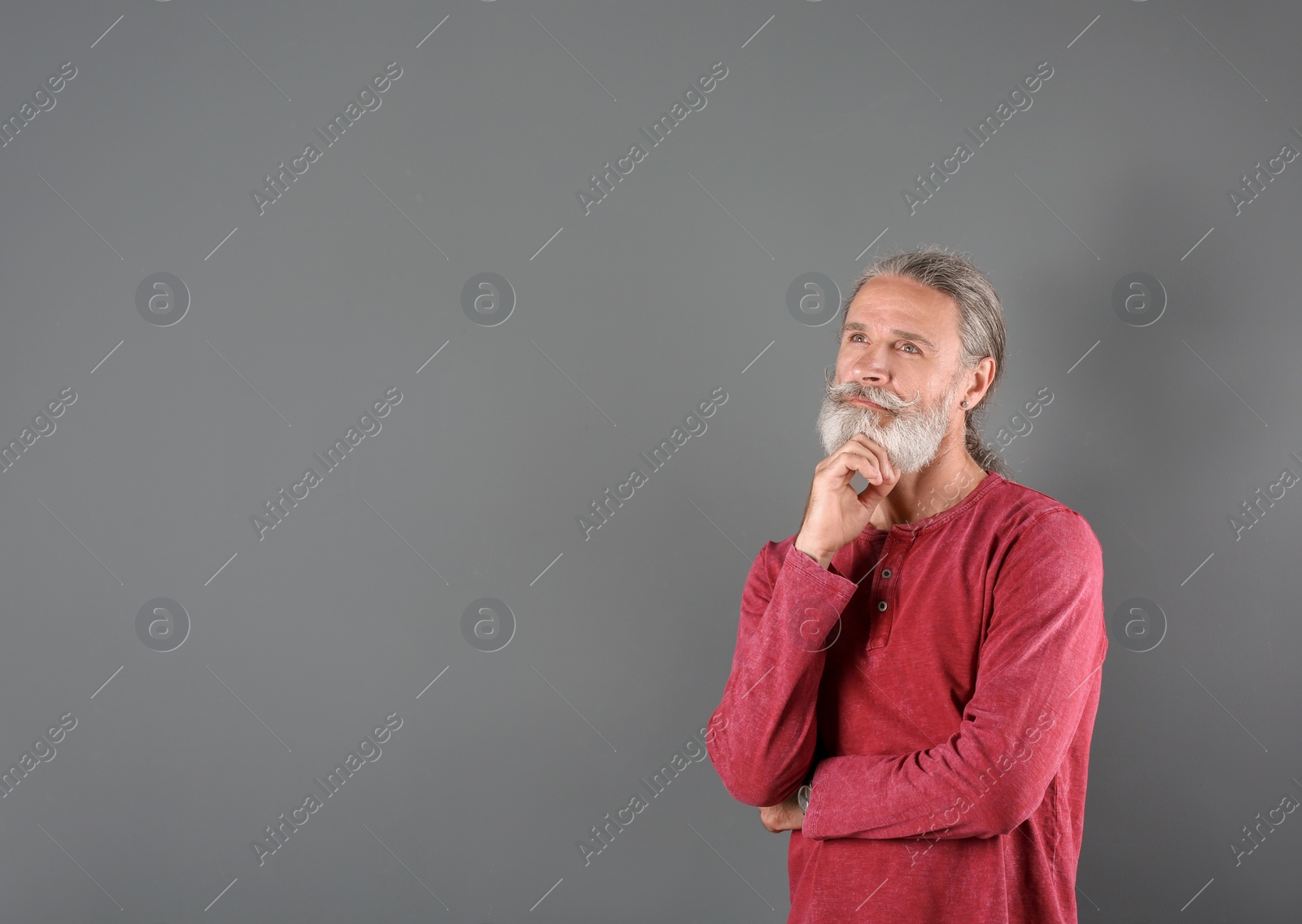 Photo of Portrait of handsome mature man on color background