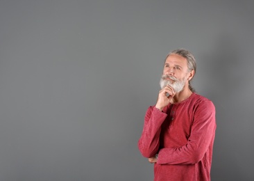 Photo of Portrait of handsome mature man on color background