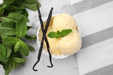 Delicious ice cream, mint and vanilla pods on white marble table, flat lay