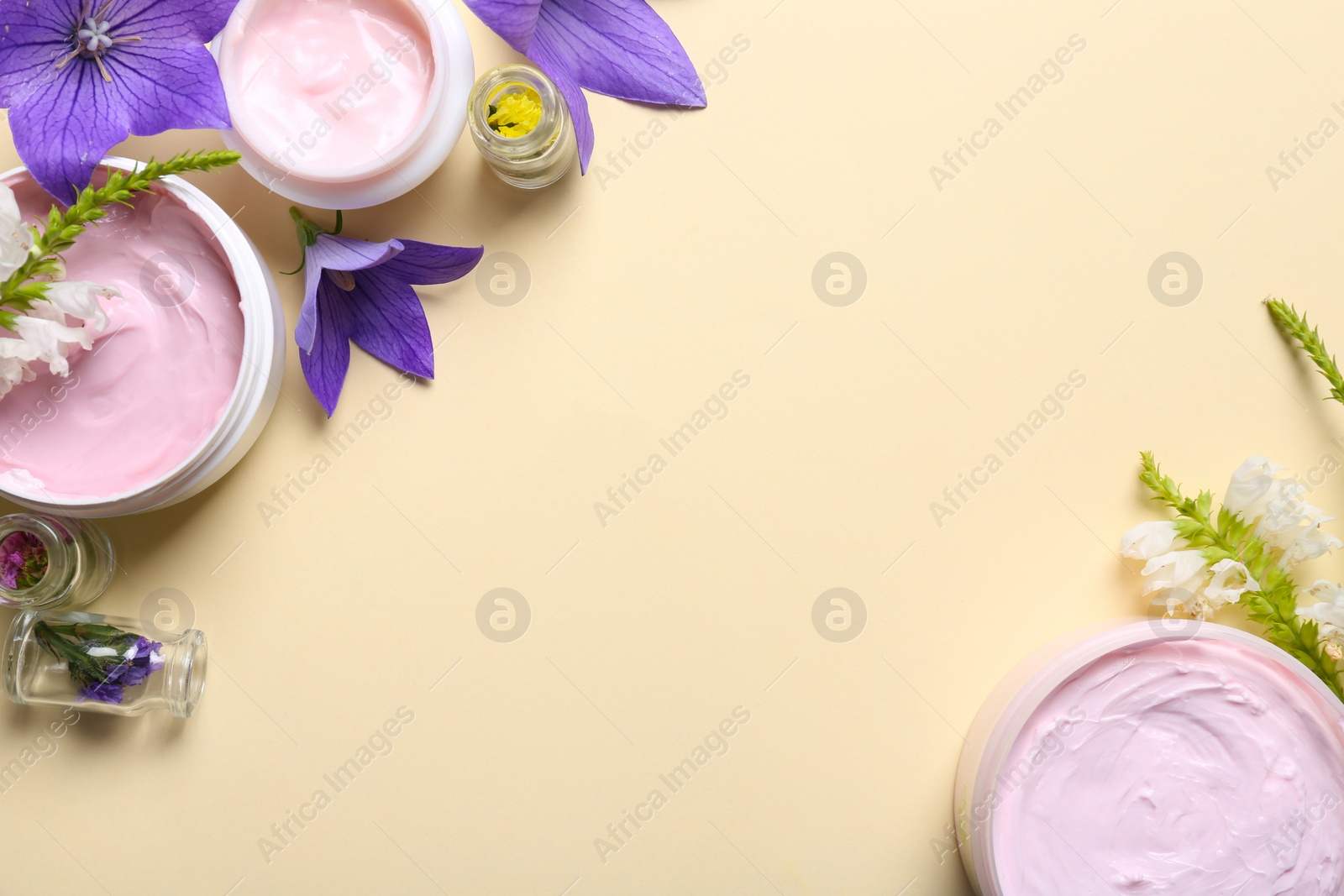 Photo of Flat lay composition with jars of body cream on beige background. Space for text