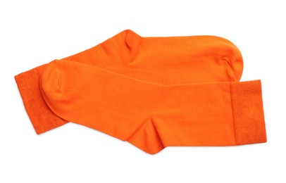 Photo of Pair of orange socks on white background, top view